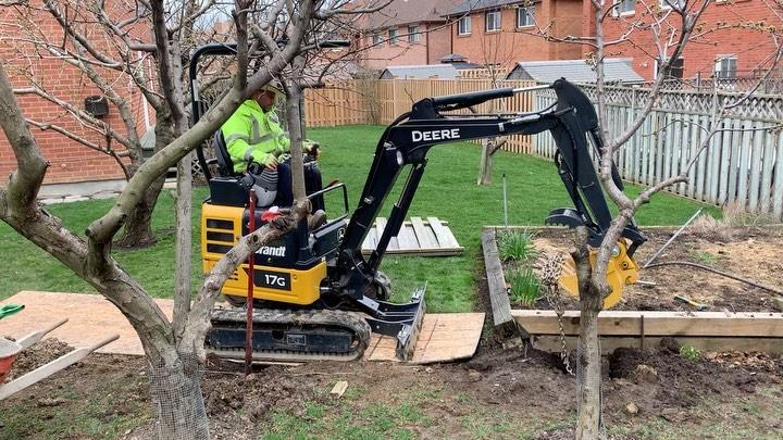 Mini excavator digging out a backyard for a new patio