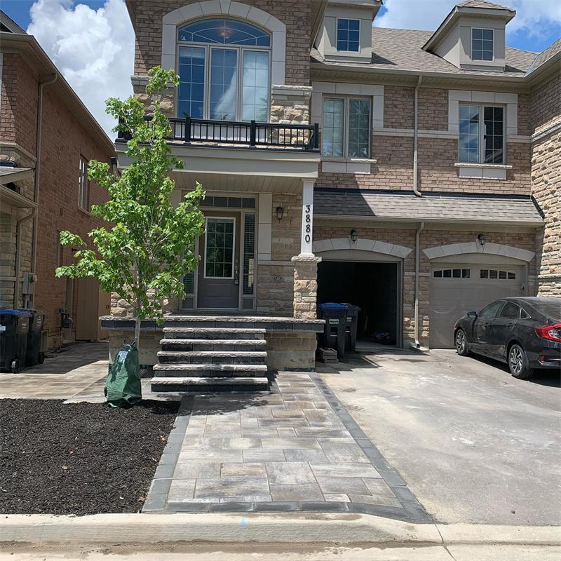 Interlock walkway and steps in front of a townhouse
