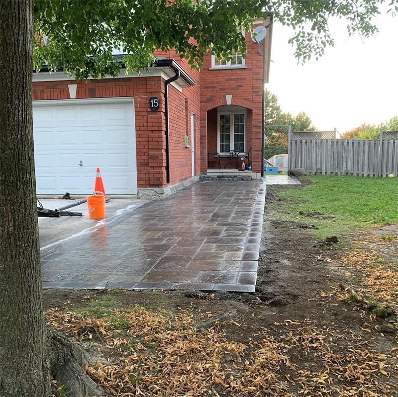New interlock walkway running beside a garage